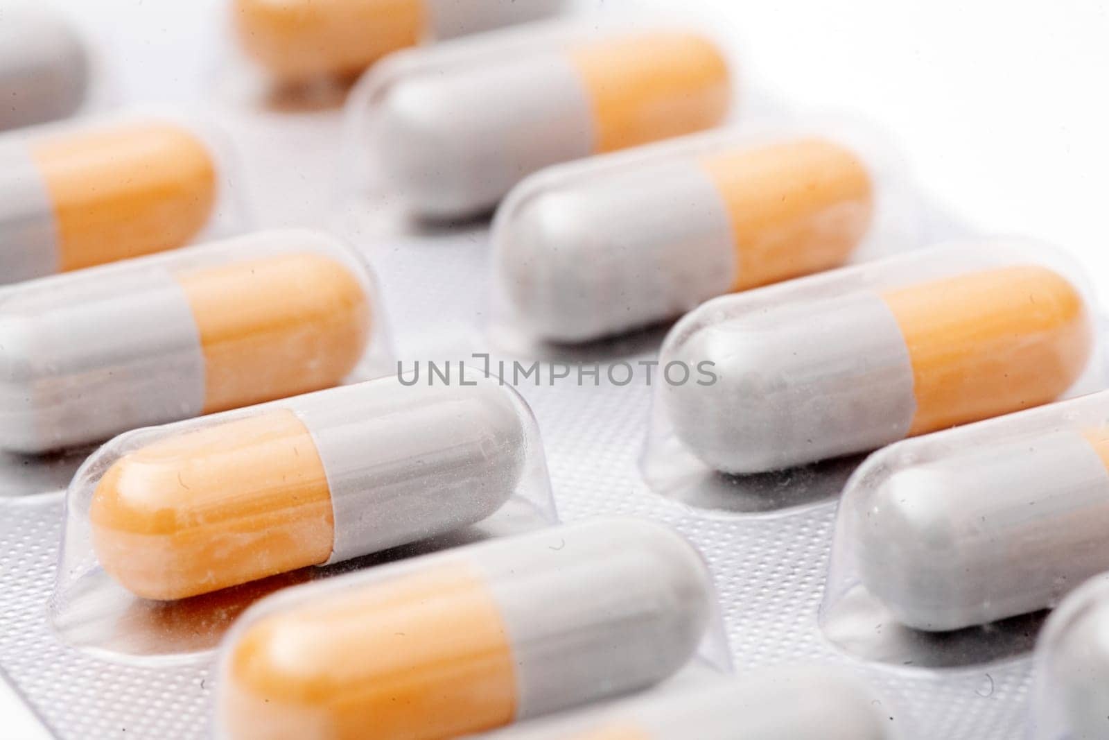 blister pack of white-orange pills isolated on white background