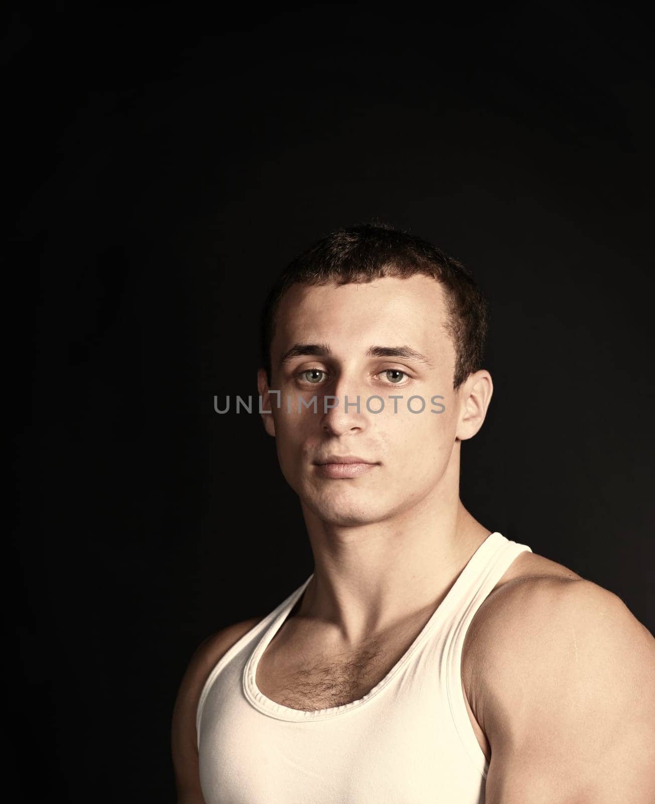 handsome guy in tank top on the black (seoia toned)