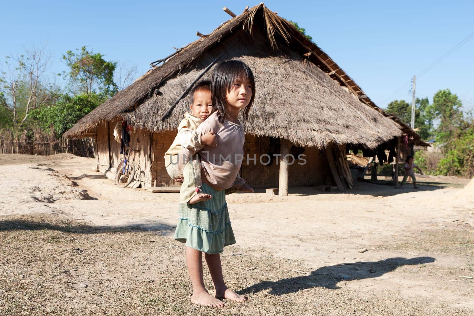 Children in poverty,sister has little brother piggybacking