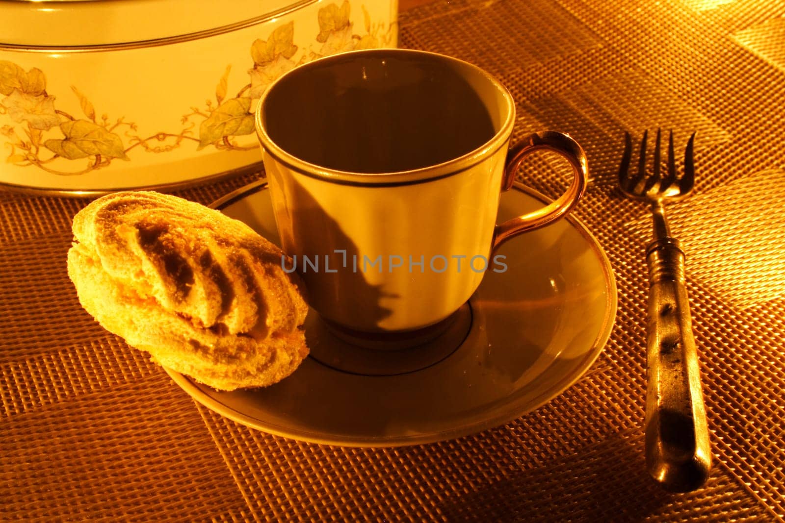 a cup of tea with zephyr on a candle light