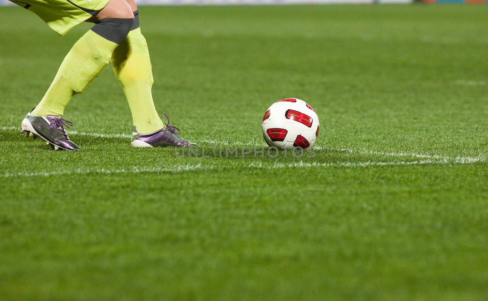 Soccer players running after the ball