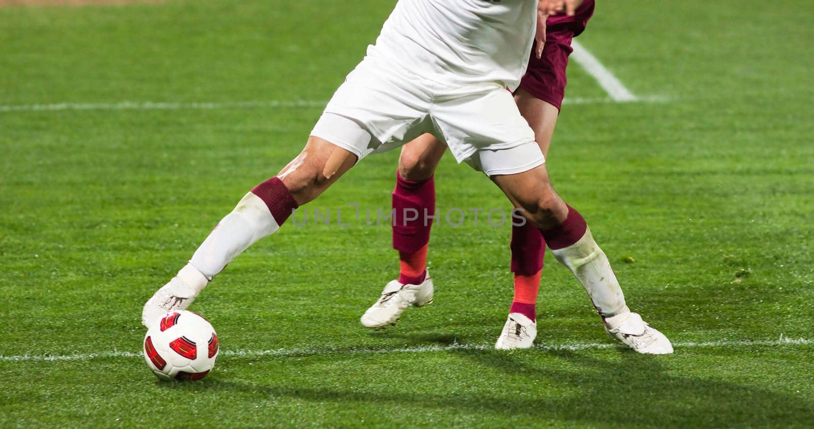 Soccer players running after the ball