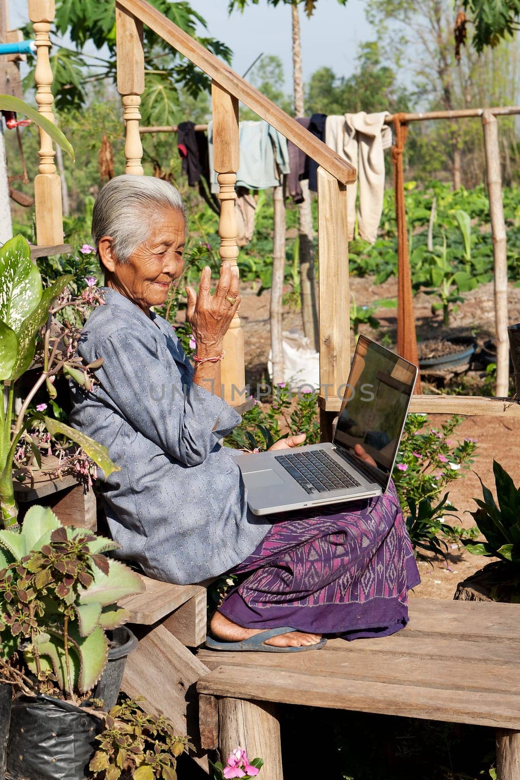 Old woman with laptop,wireless connection in remote places