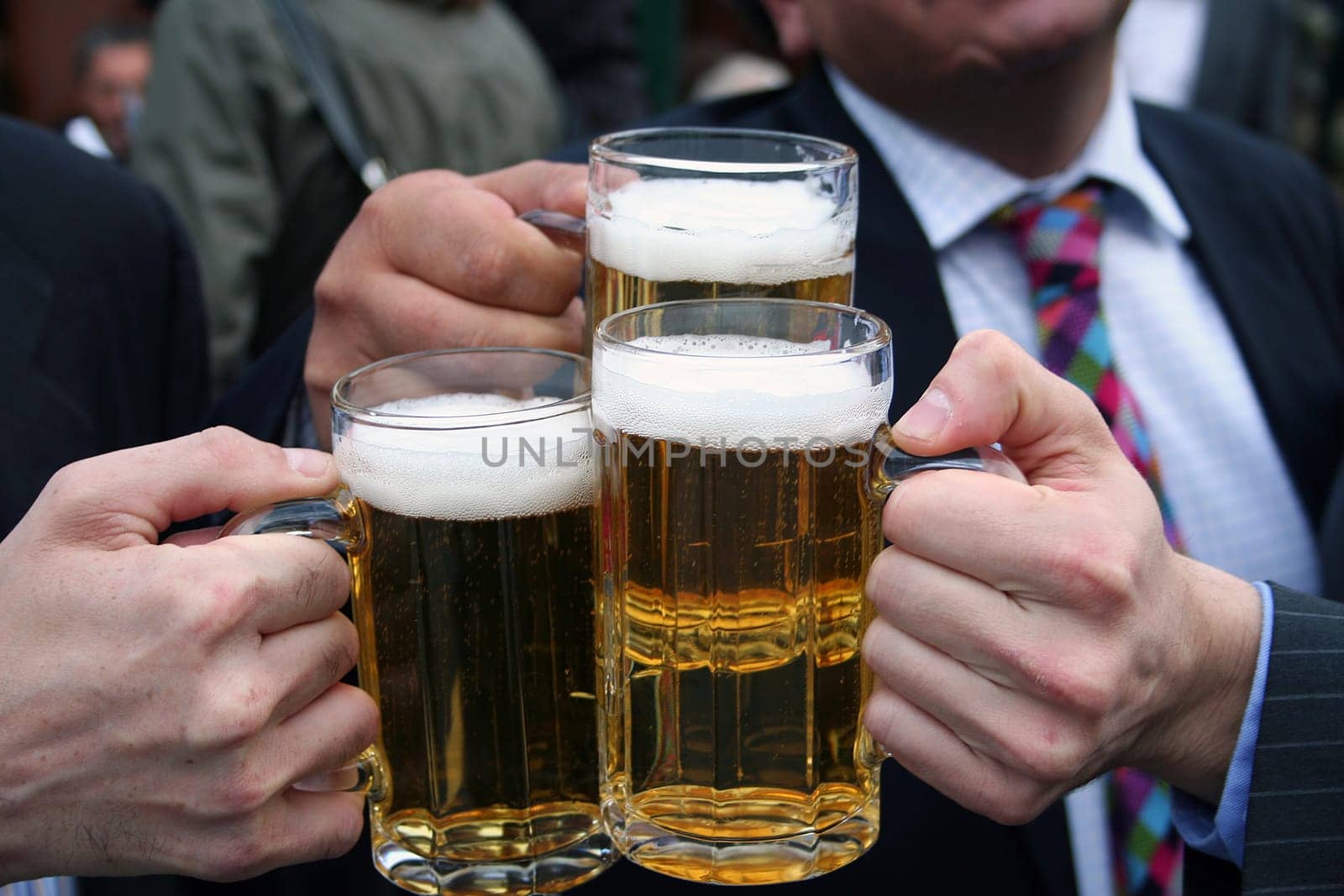 business men toasting with their beers
