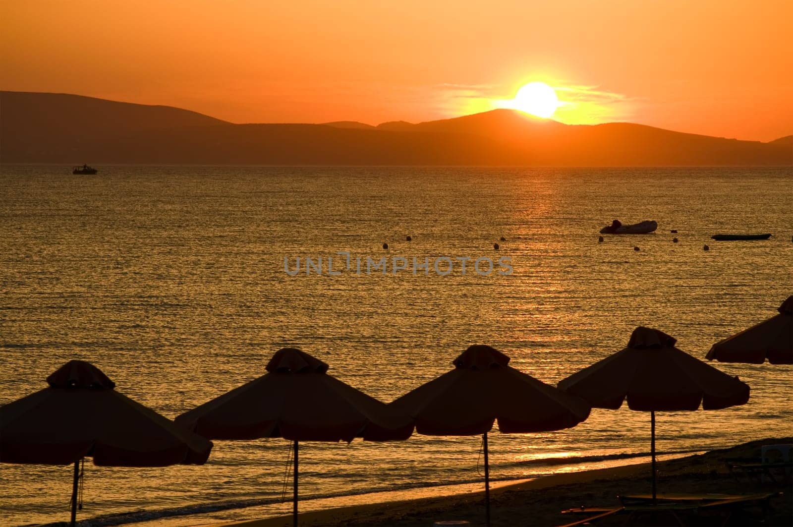 View from the beach with a glowing sun setting in the horizont