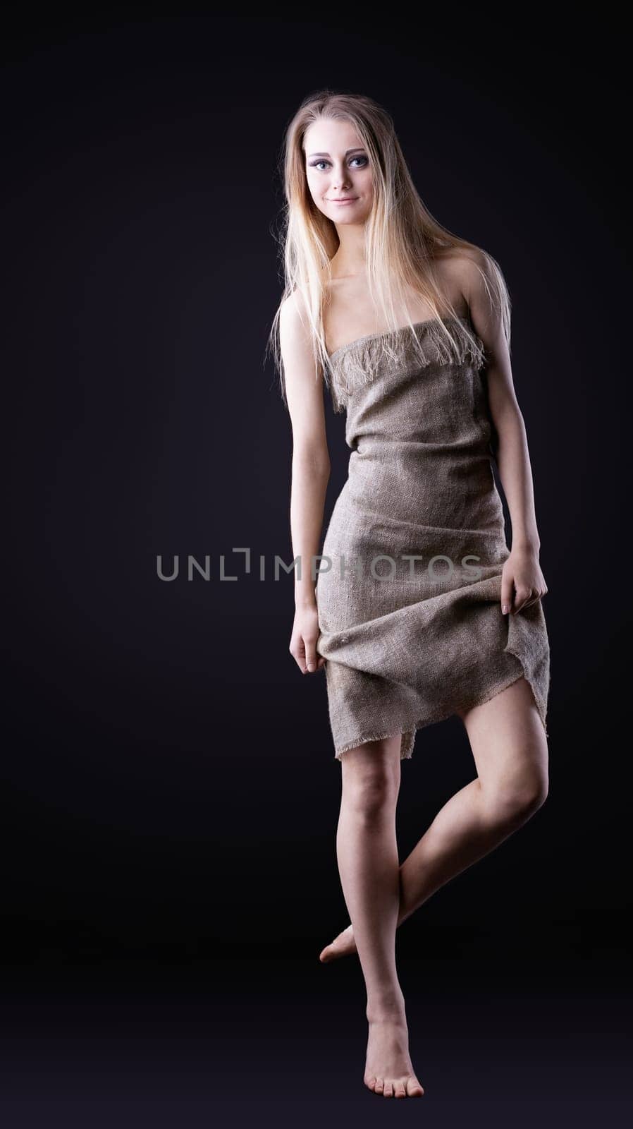 Beauty blond Girl walk in rag from dark