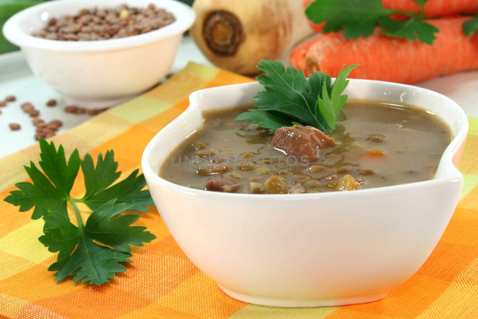 a bowl of lentil soup with bacon and parsley