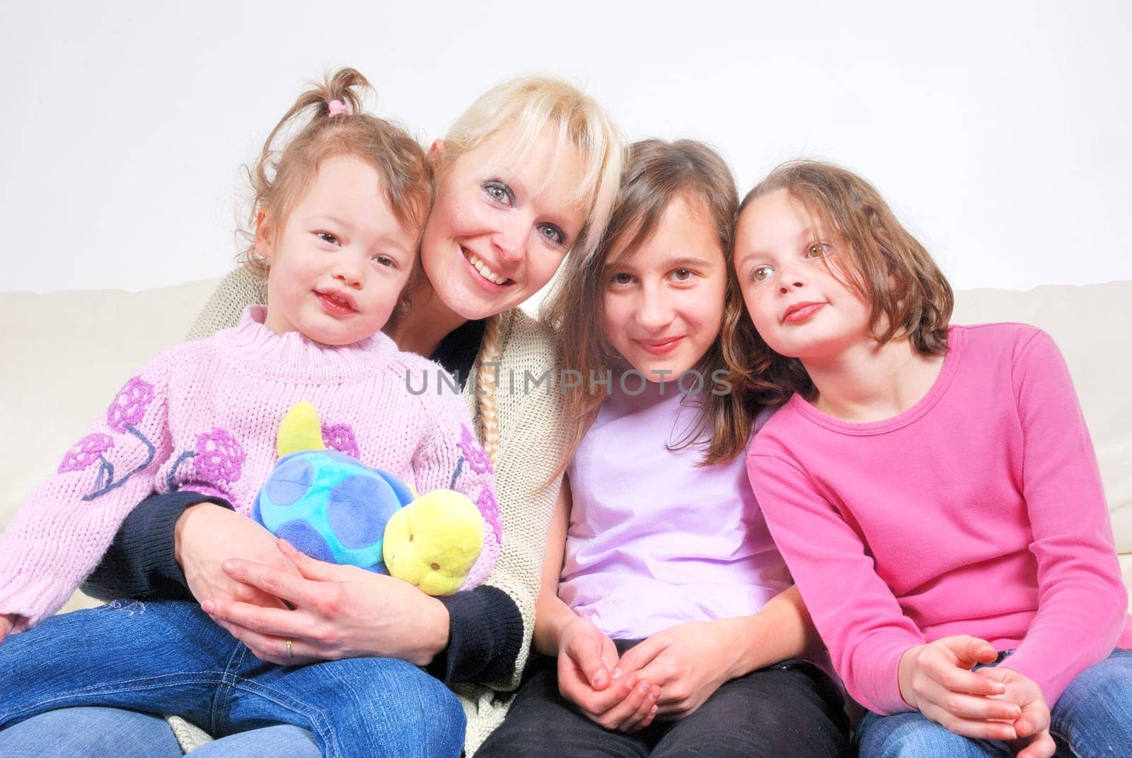Family sitting in living room on sofa