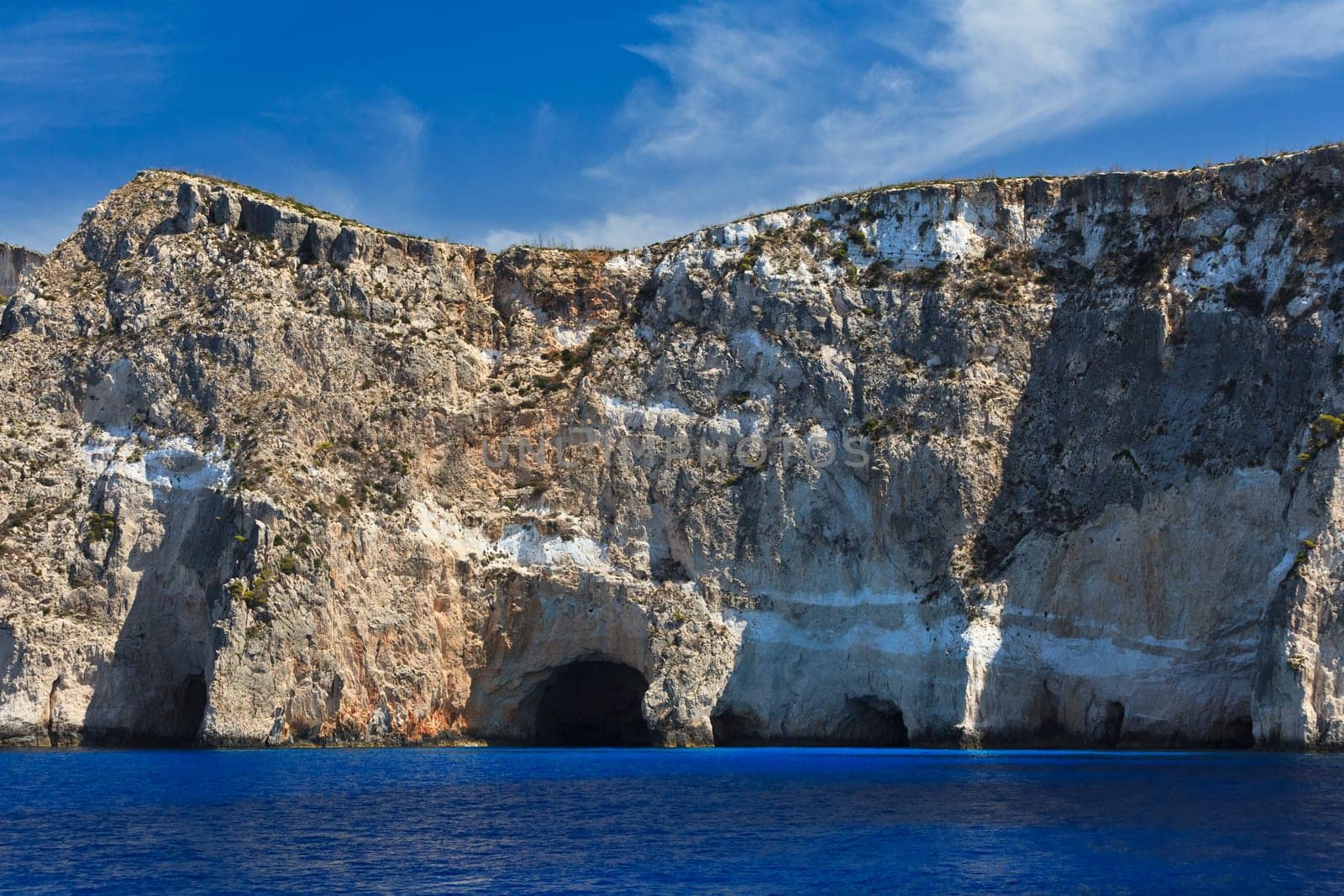 a mountain slope near a blue sea