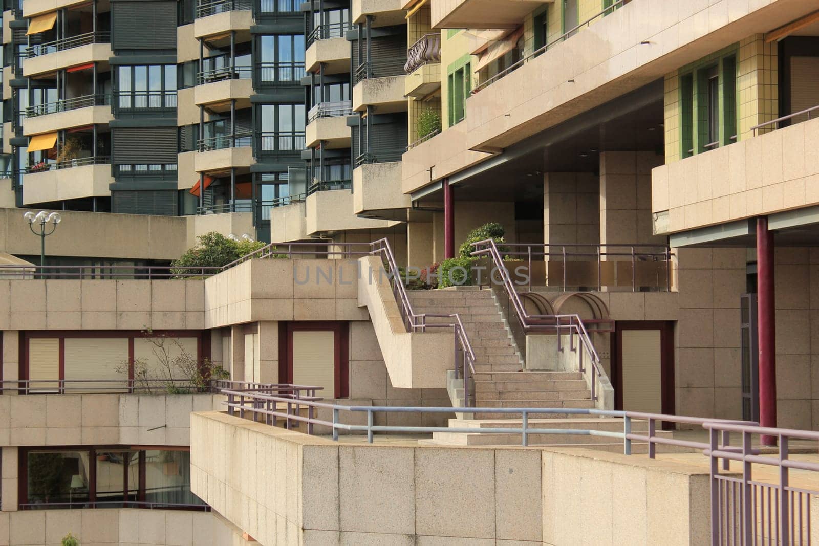 Close up of the facade with balconies, windows and staircases of a modern building