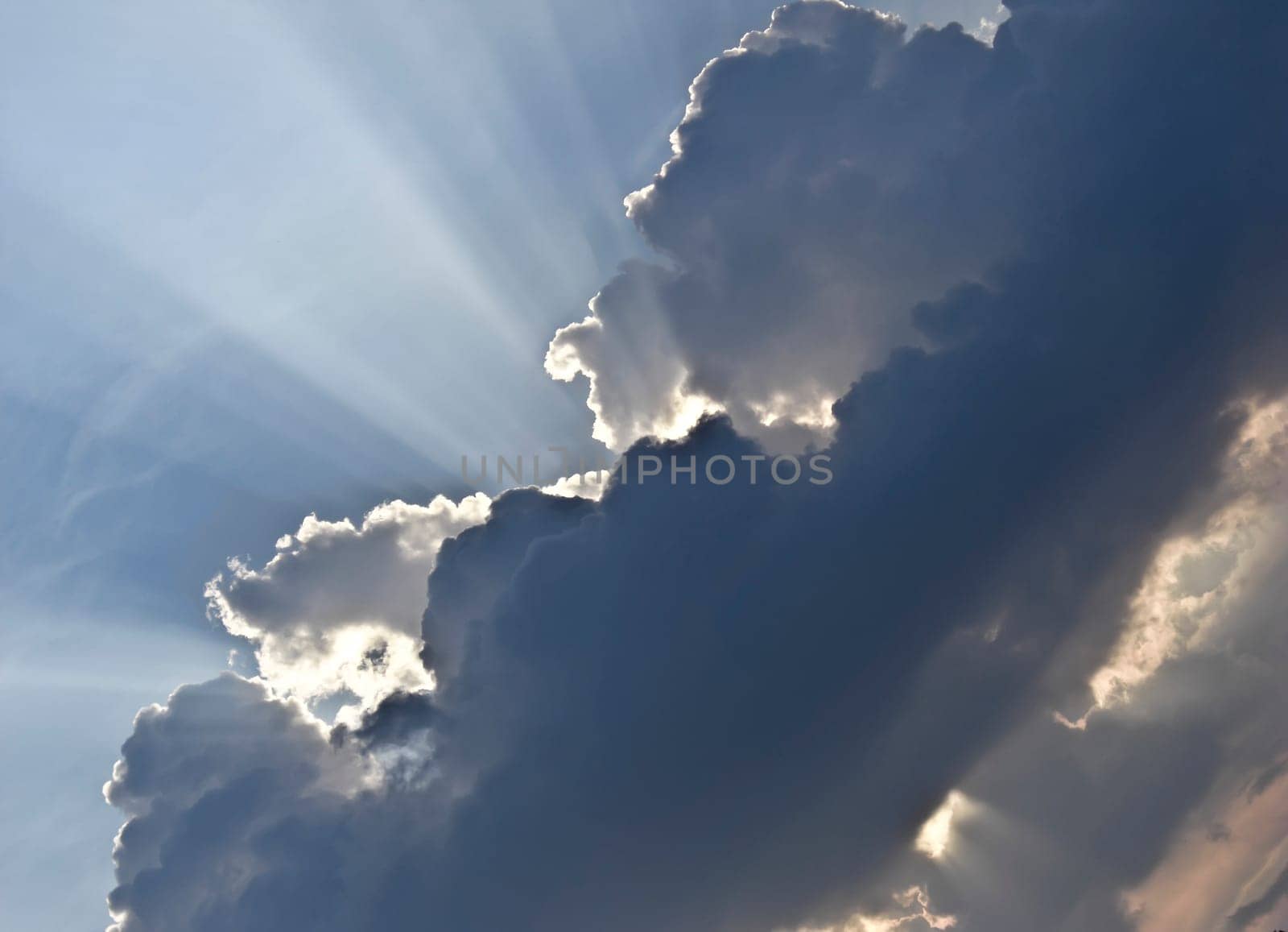 Sunbeam behind dark Clouds after a stormy weather