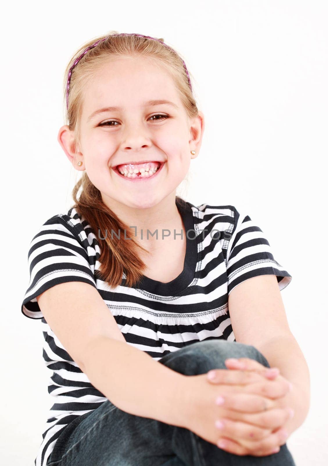 Happy girl with her first missing tooth