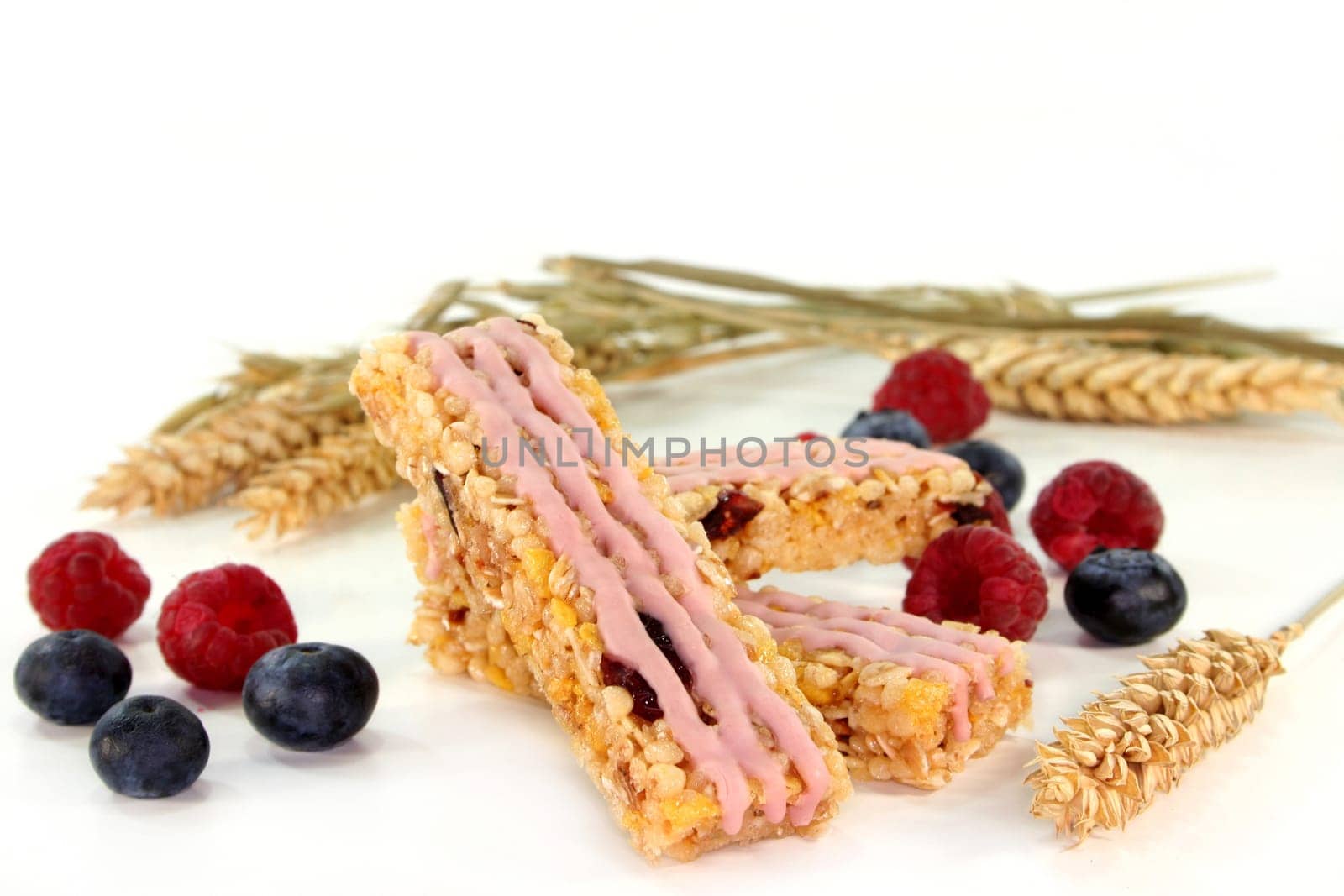 a muesli bar with raspberries and blueberries