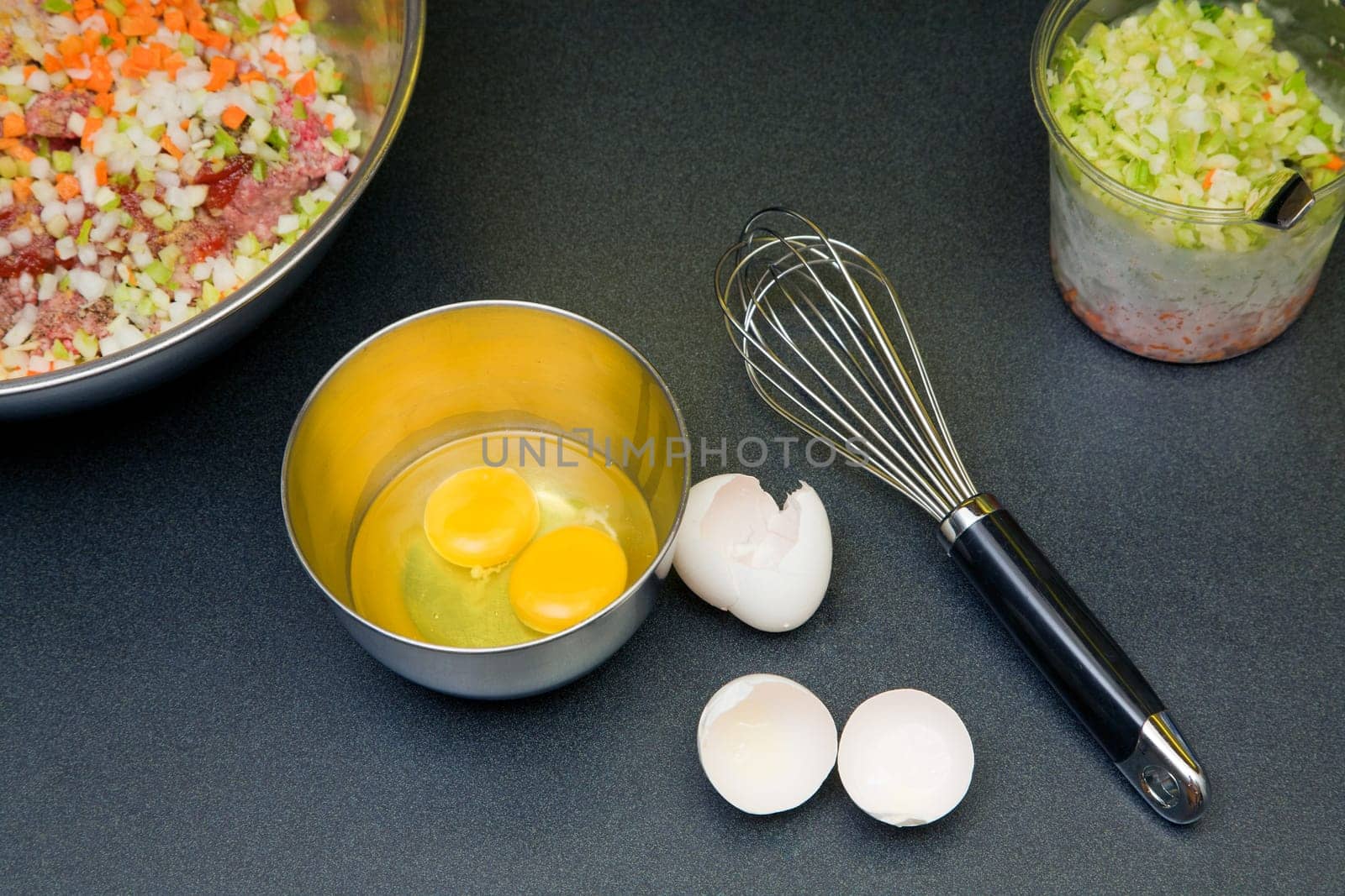 Two eggs in the ball with other ingredients for meatloaf