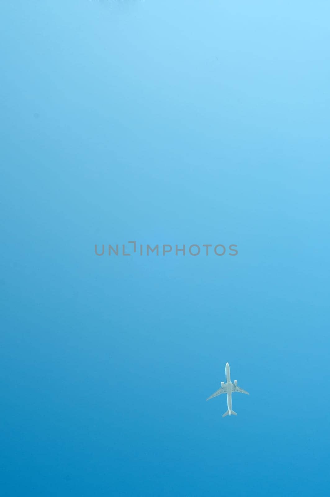 Small airplane on blue sky flying high