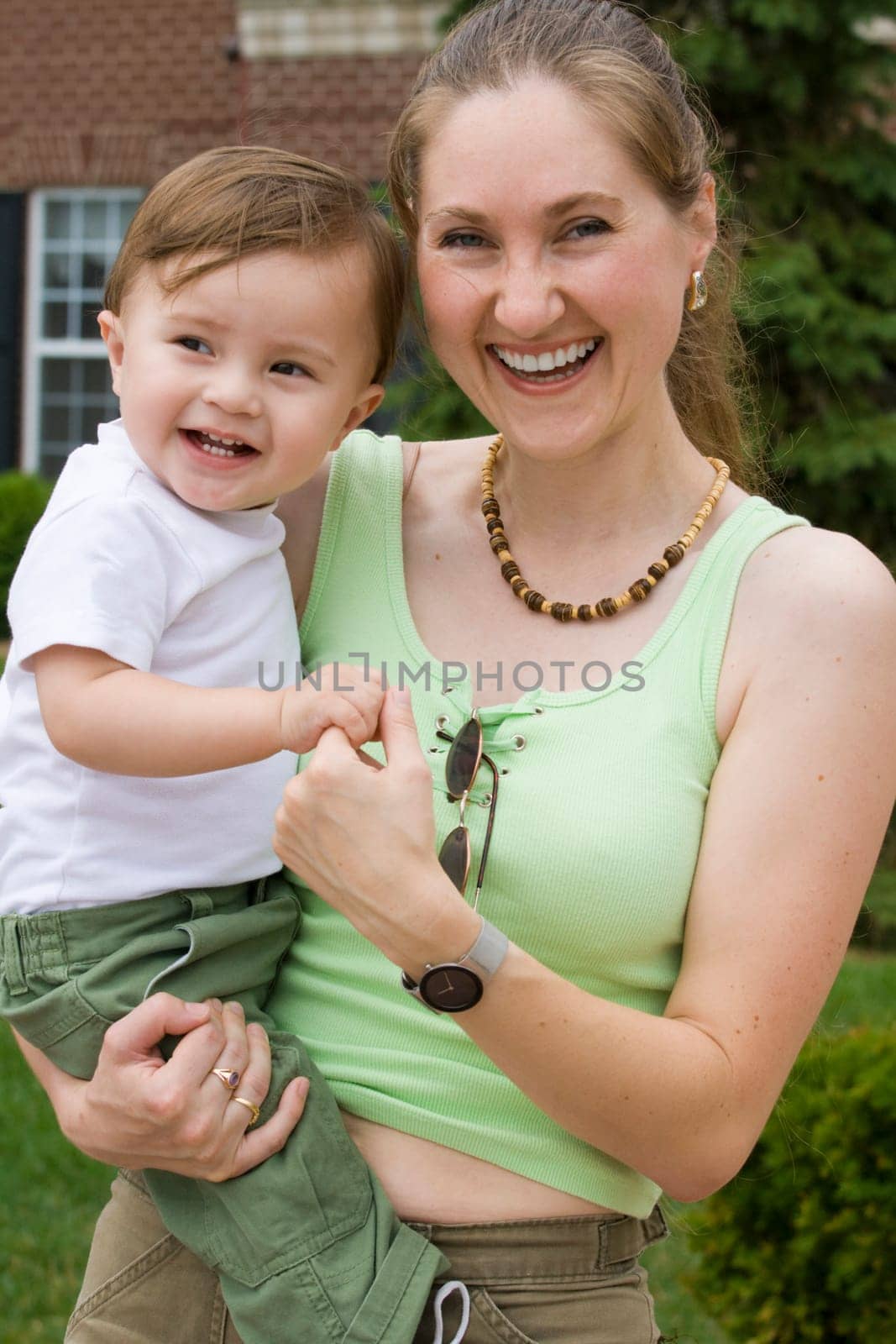 Happy young mother holding her 1-year-old son
