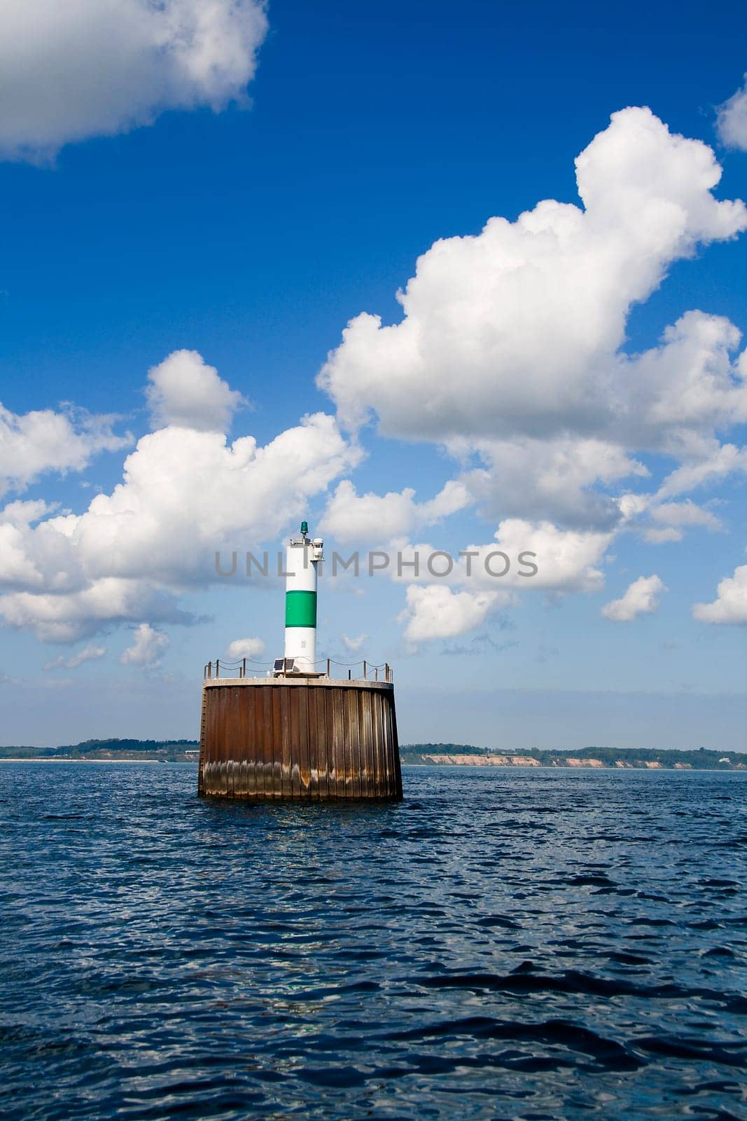 Stand-alone lighthouse used as a navigational marker for harbor entrance