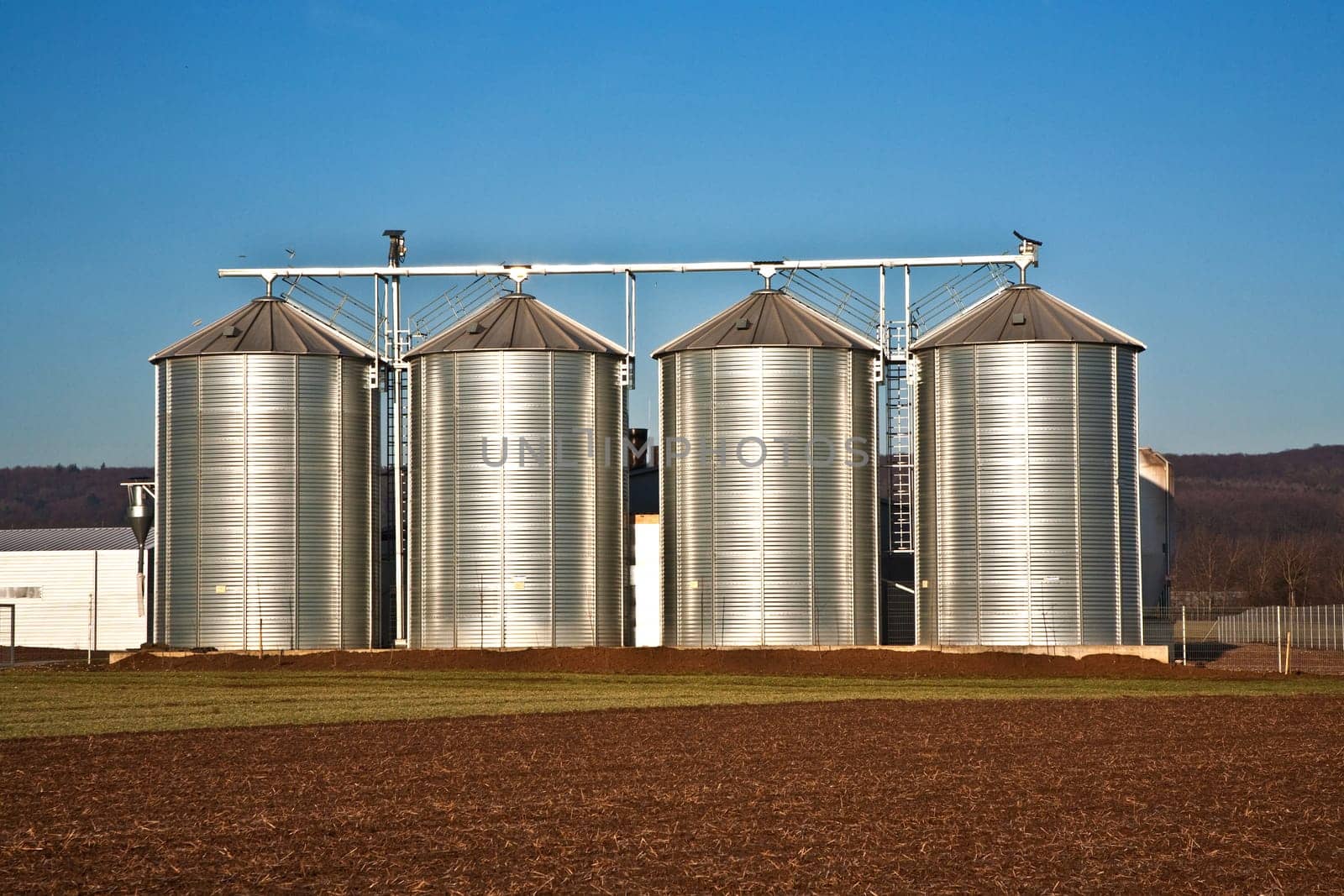 beautiful landscape with silo and snow white acre with blue sky