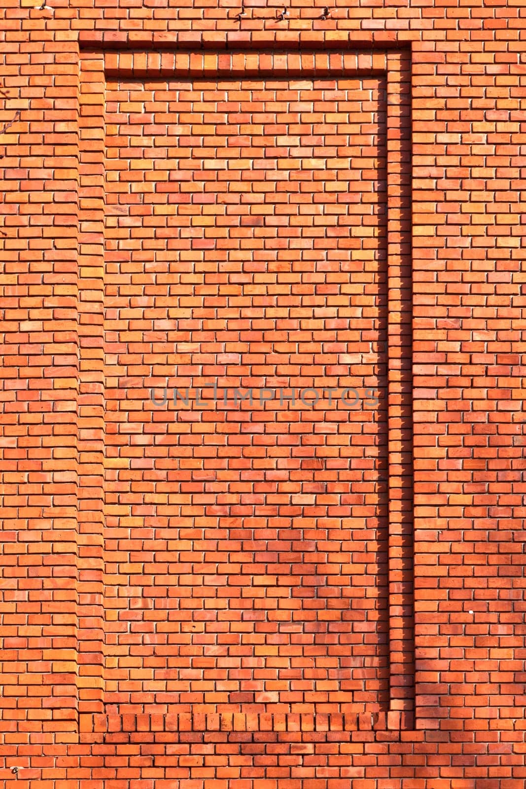 red brick wall of an old house with shadow