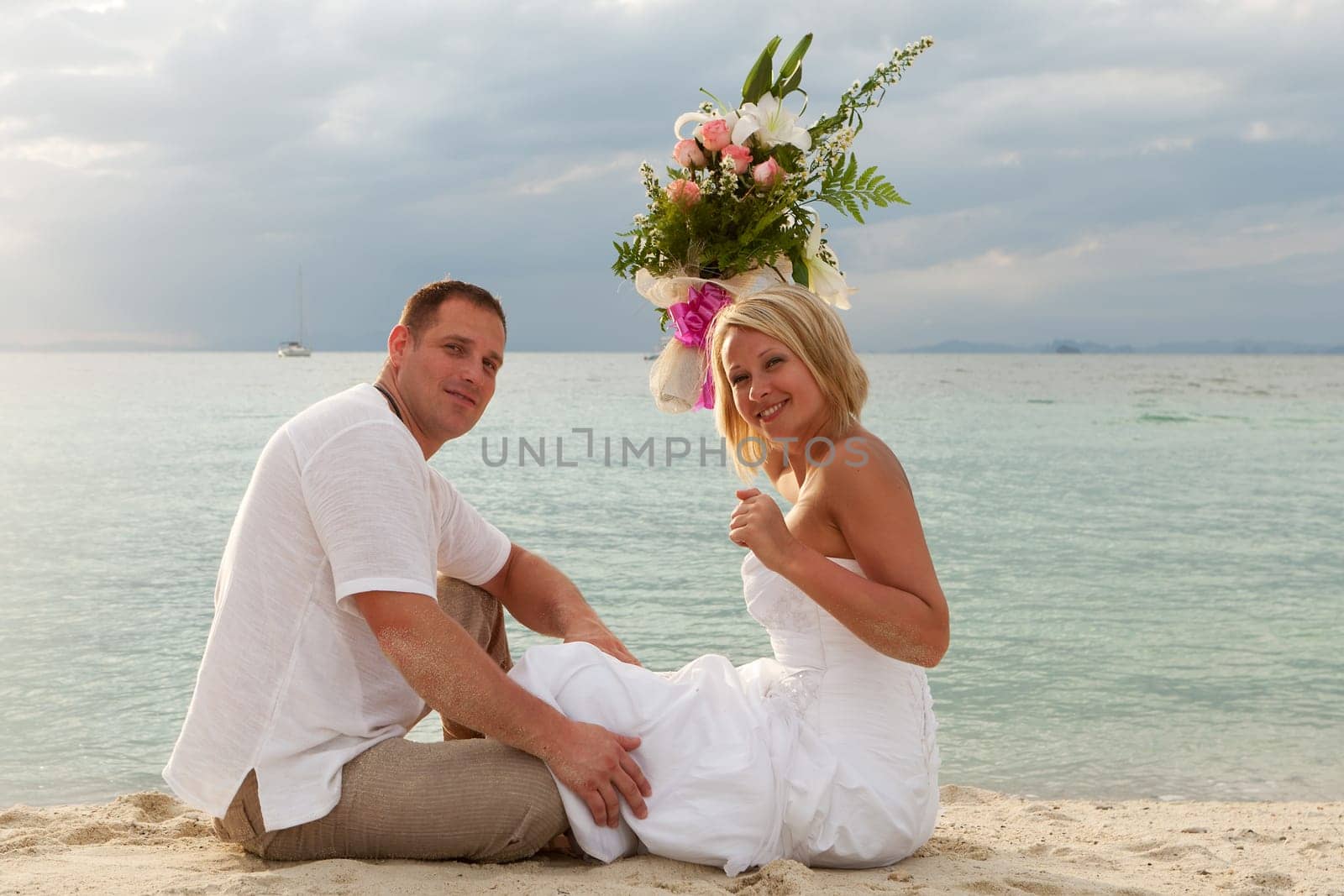 Wedding,couple traveling with wedding dress on the beach