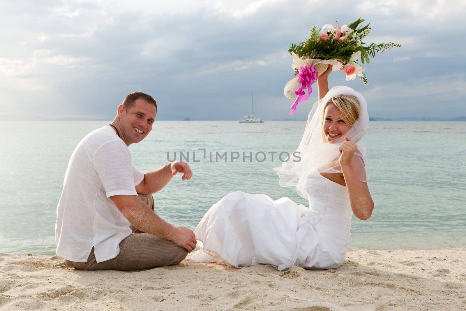 Wedding,couple traveling with wedding dress on the beach