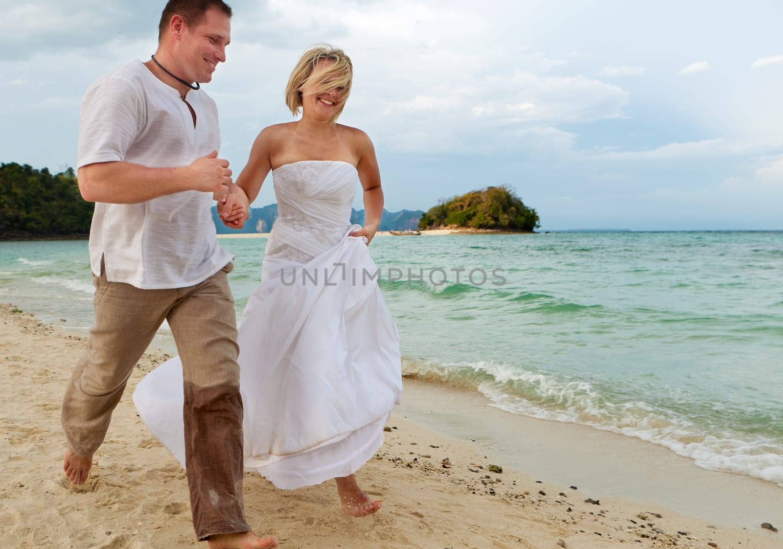 Running on the beach,couple in love on their honeymoon by the sea