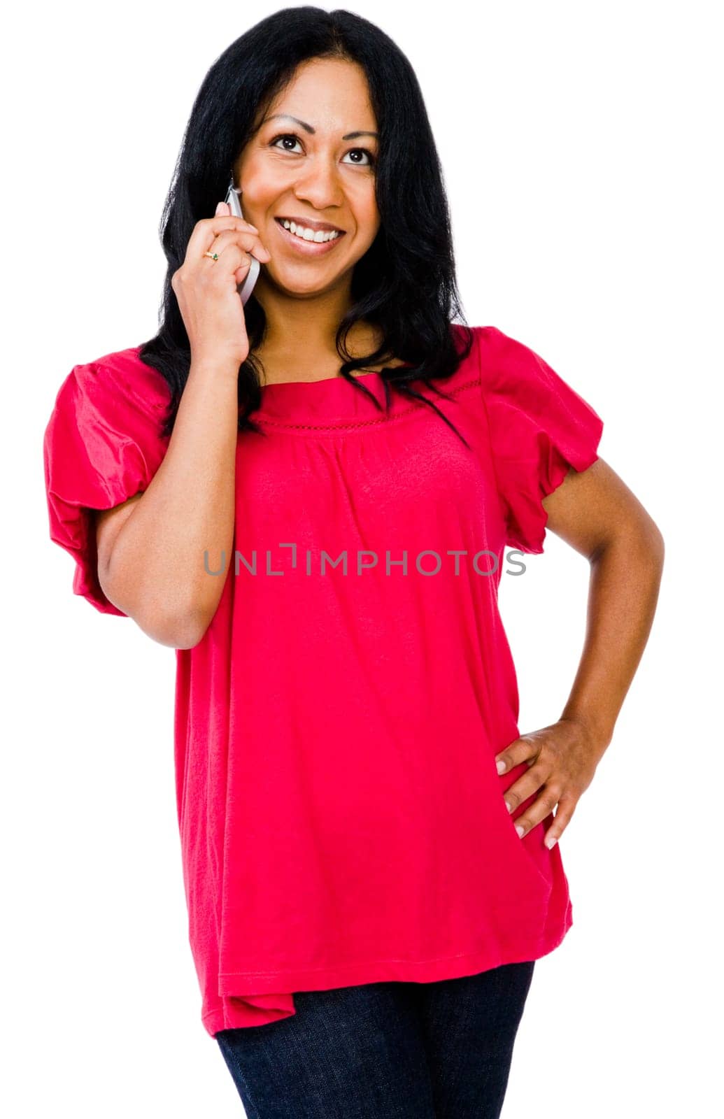 Woman talking on a mobile phone and smiling isolated over white
