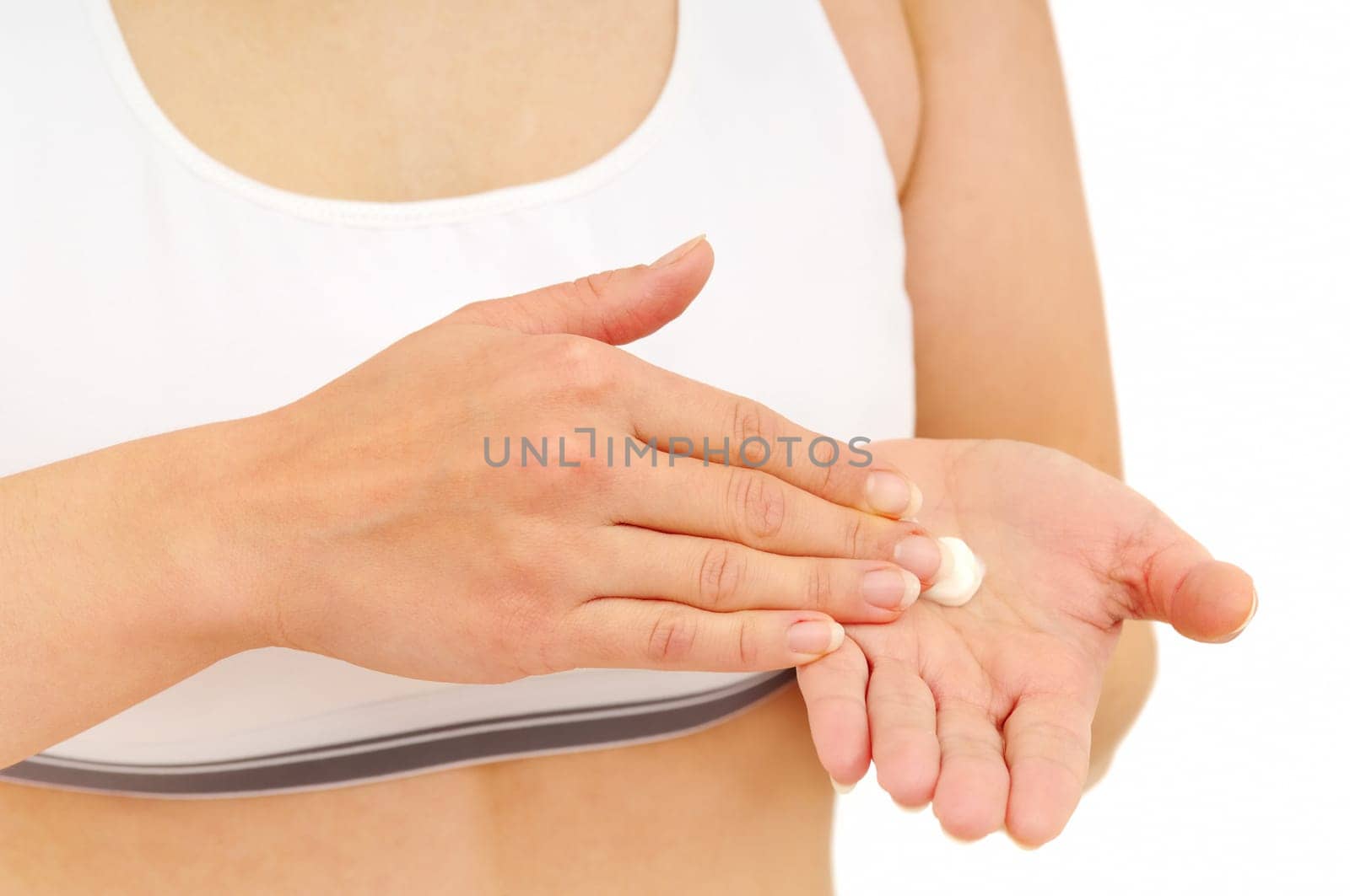 Woman in underwear applies cream on dry hands