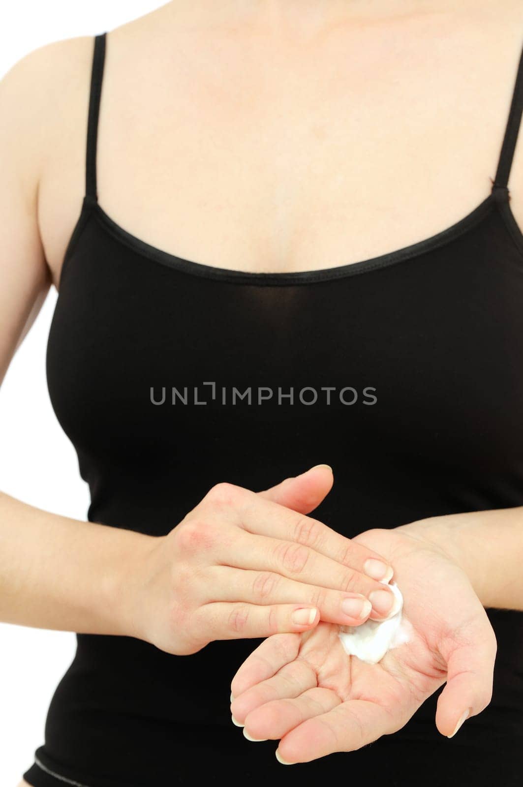 Woman in underwear treats her dry hands with cream