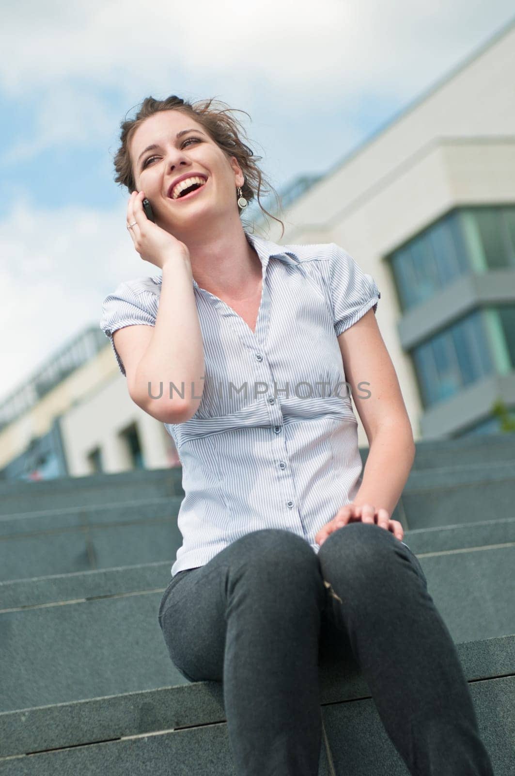 Young beautiful laughing woman calling with mobile phone