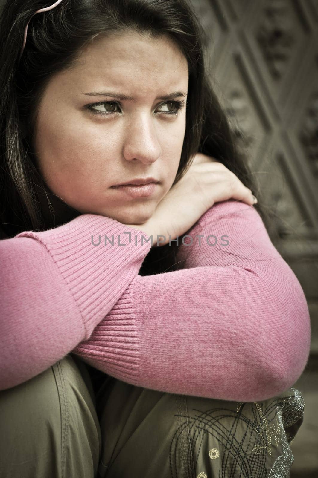 Portrait of young worried woman (teenage girl) in depression outdoors