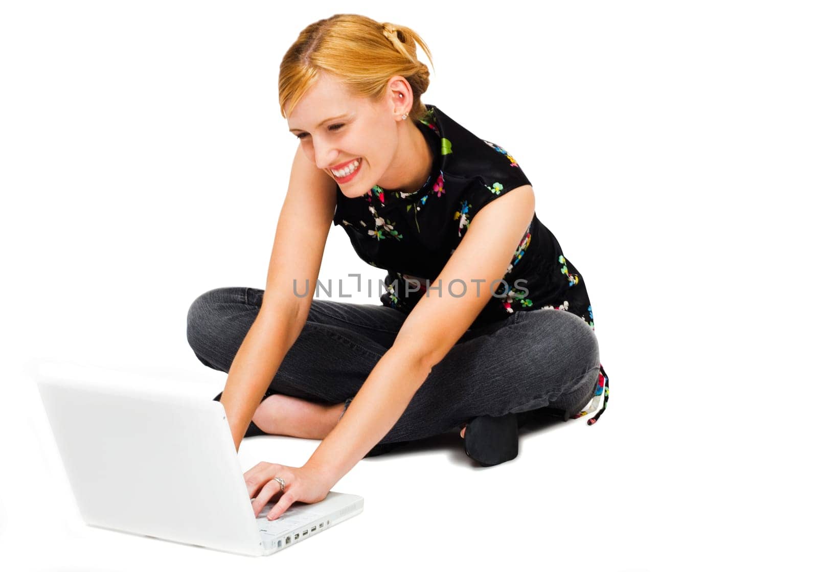 Woman using a laptop and smiling isolated over white