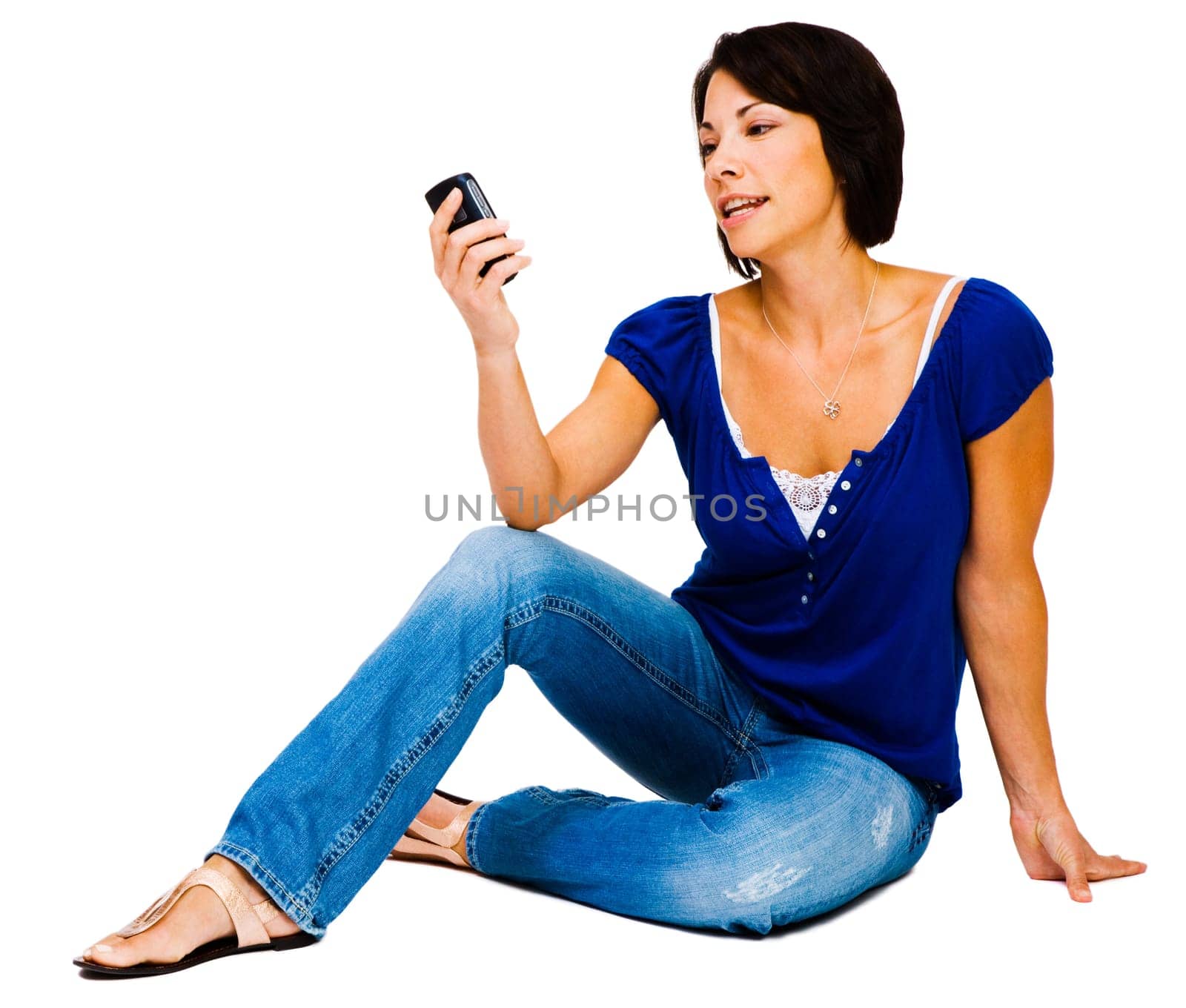 Woman text messaging on a mobile phone and smiling isolated over white