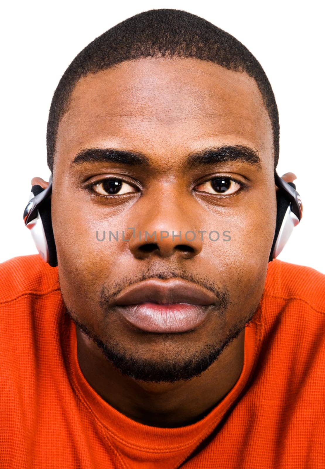 Young man wearing headphones and listening to music isolated over white