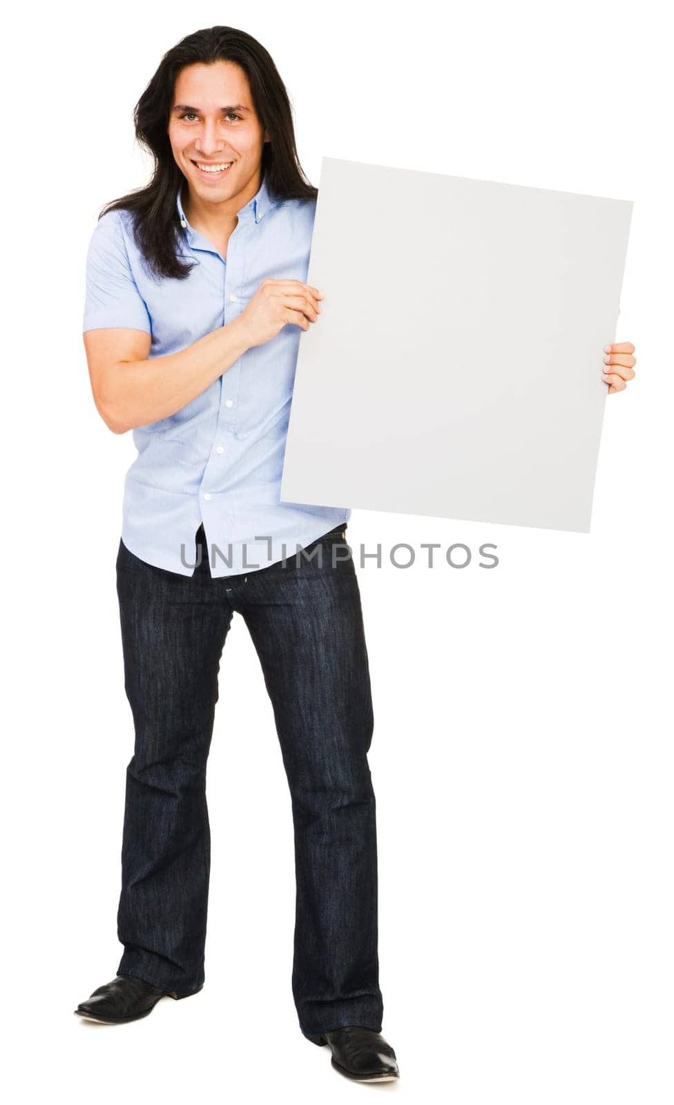 Handsome young man holding a placard isolated over white