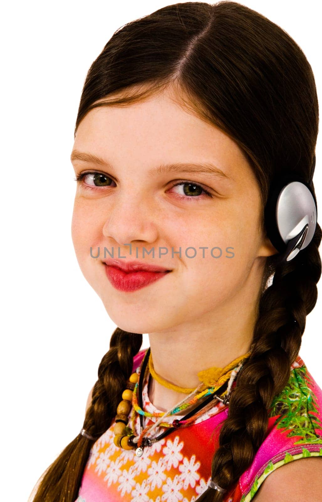 Beautiful girl listening to music on headphones isolated over white