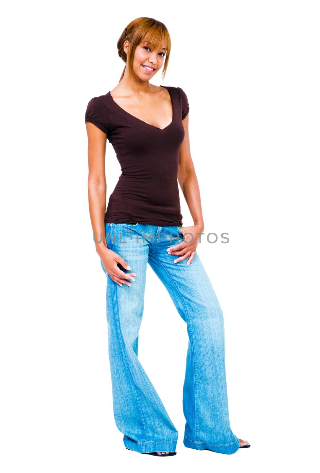 Young woman standing with her hands in her pockets isolated over white