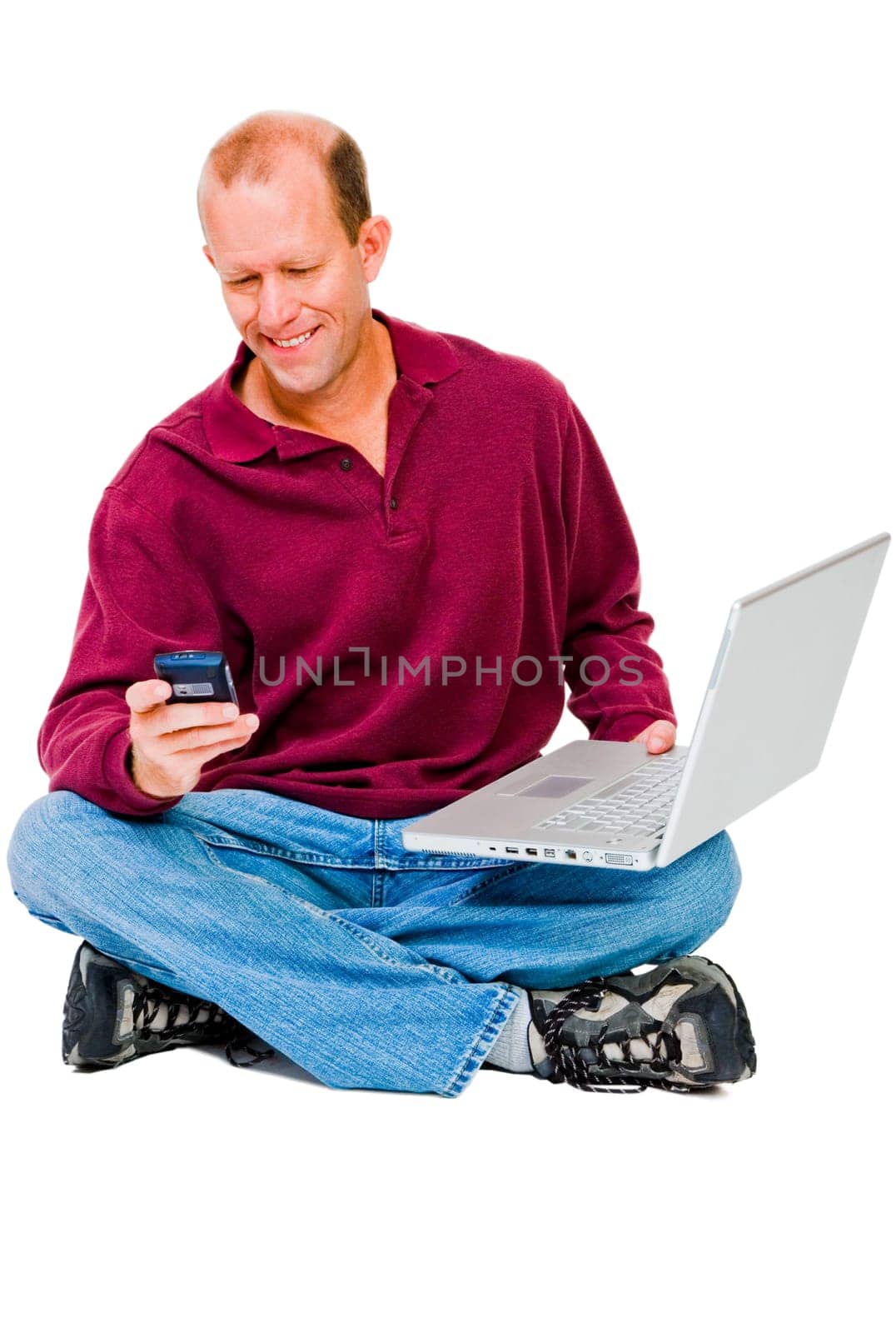 Man using a mobile phone and a laptop isolated over white