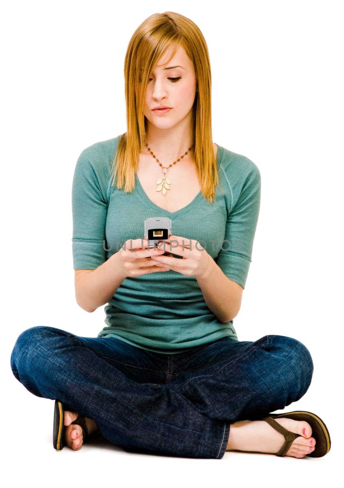 Gorgeous woman text messaging on a mobile phone isolated over white