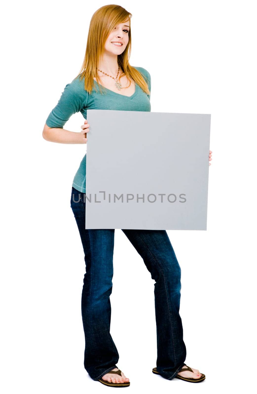 Young woman showing a placard and smiling isolated over white