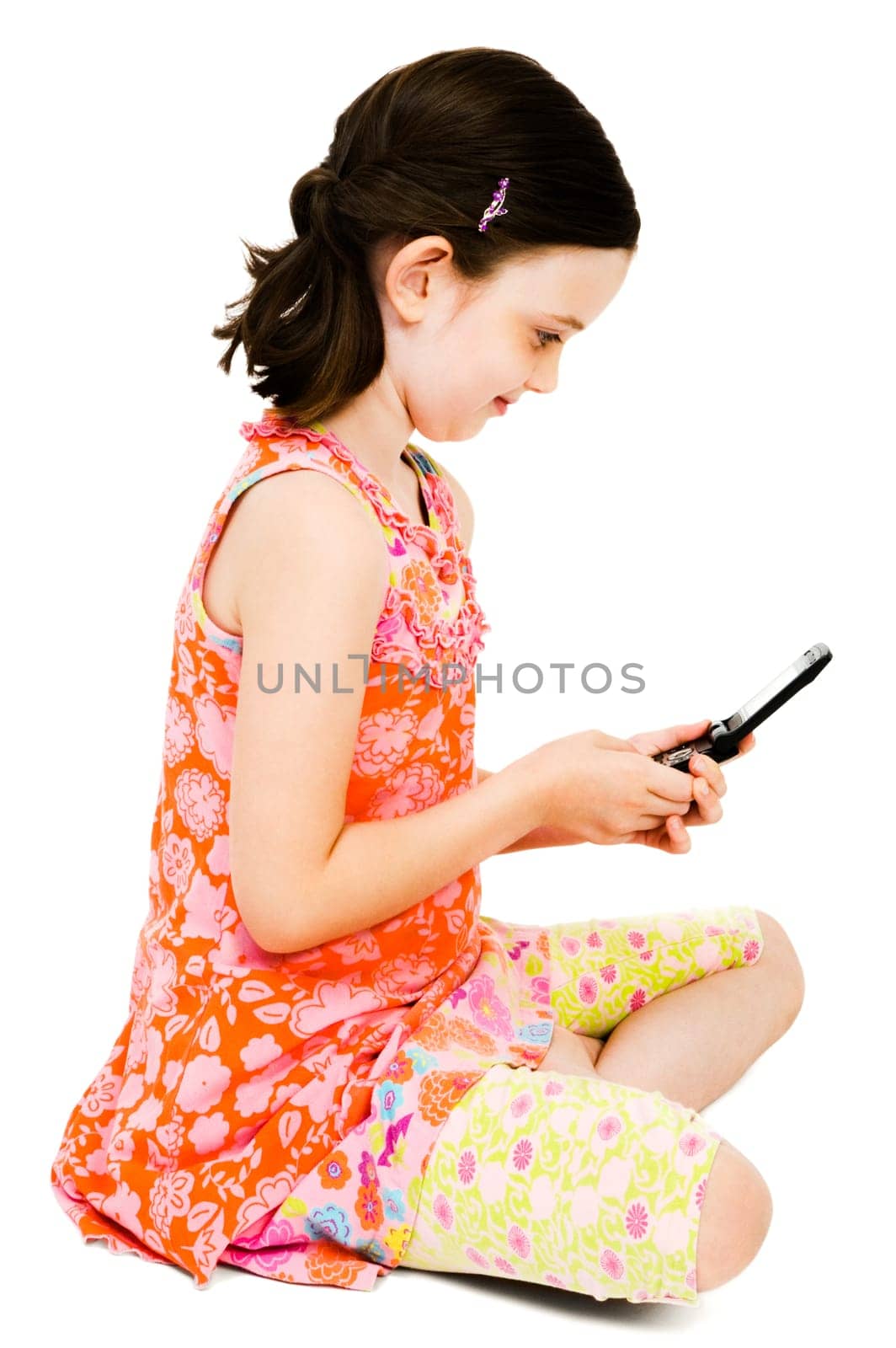 Girl text messaging on a mobile phone and smiling isolated over white