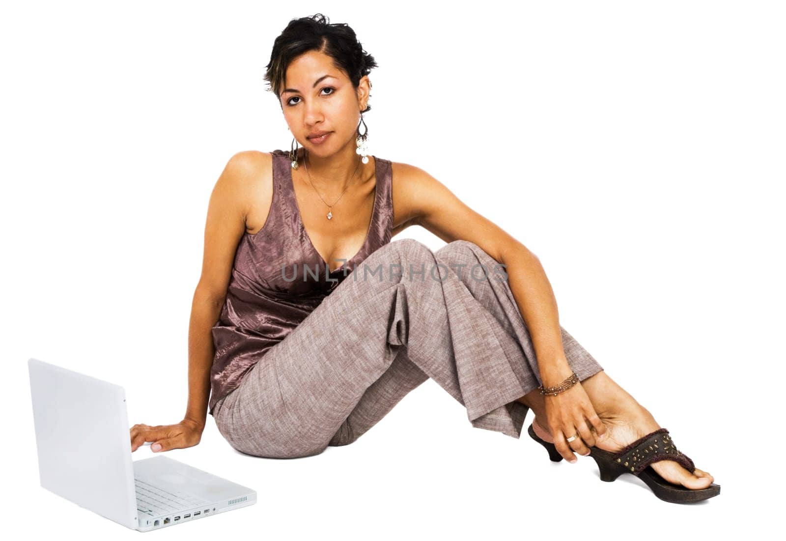 Beautiful young woman using a laptop isolated over white