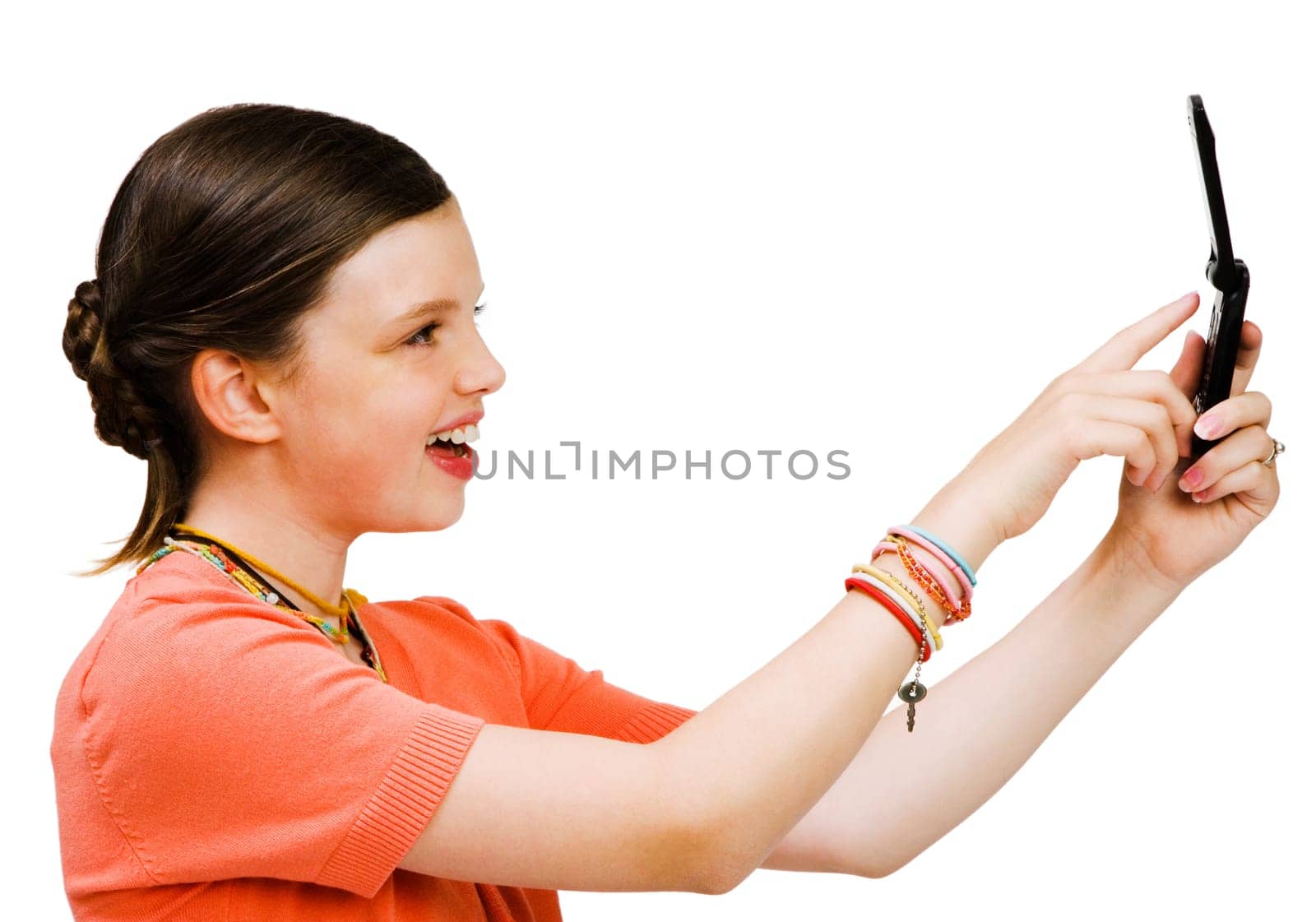 Smiling girl text messaging on a mobile phone isolated over white