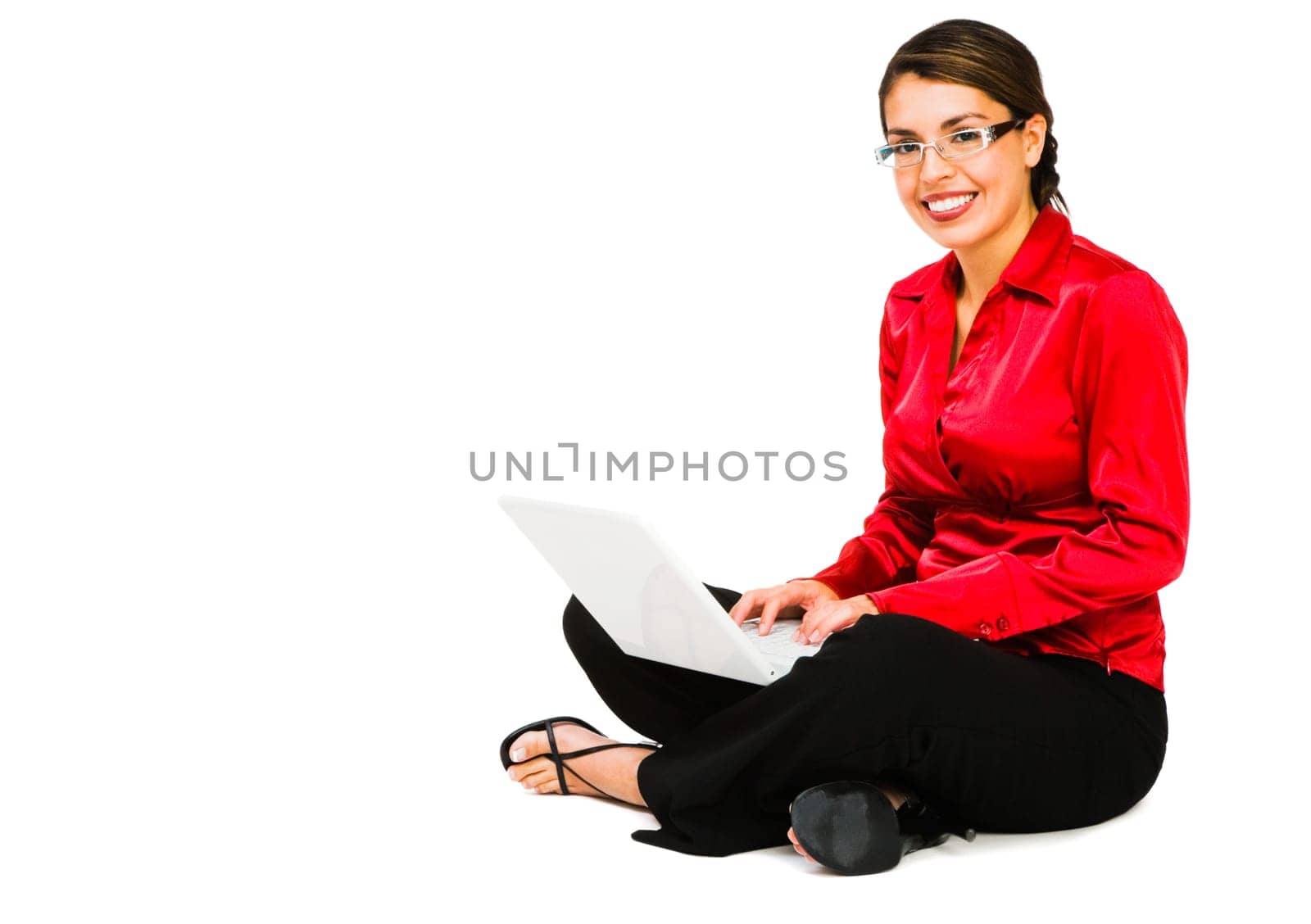 Confident businesswoman using a laptop and smiling isolated over white