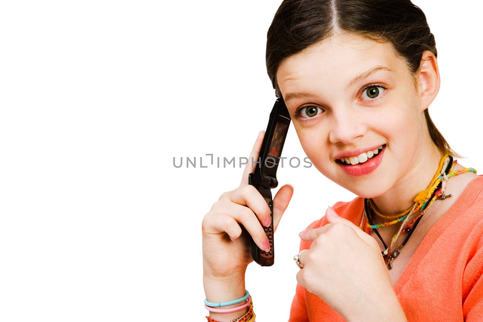 Girl talking on a mobile phone isolated over white