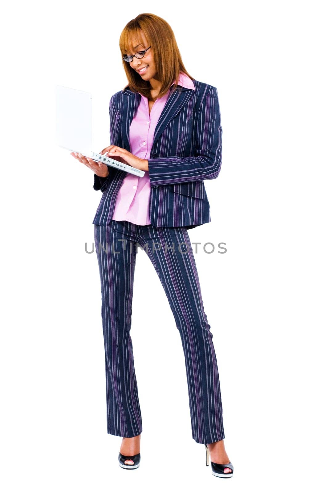 Smiling woman using a laptop isolated over white