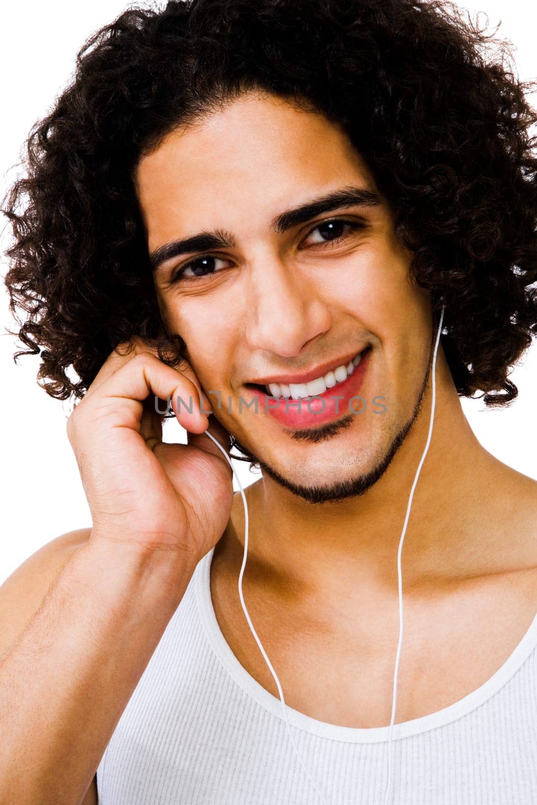 Handsome man listening to music with earbuds isolated over white