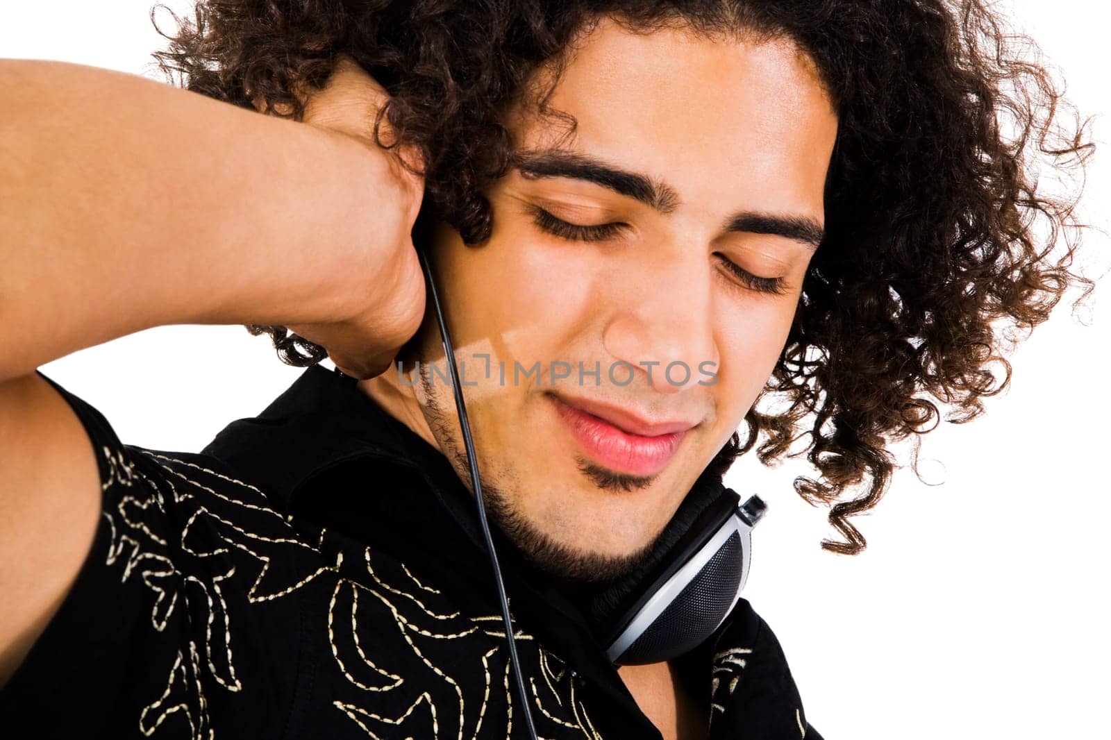 Close-up of a man wearing headphones and listening to music isolated over white