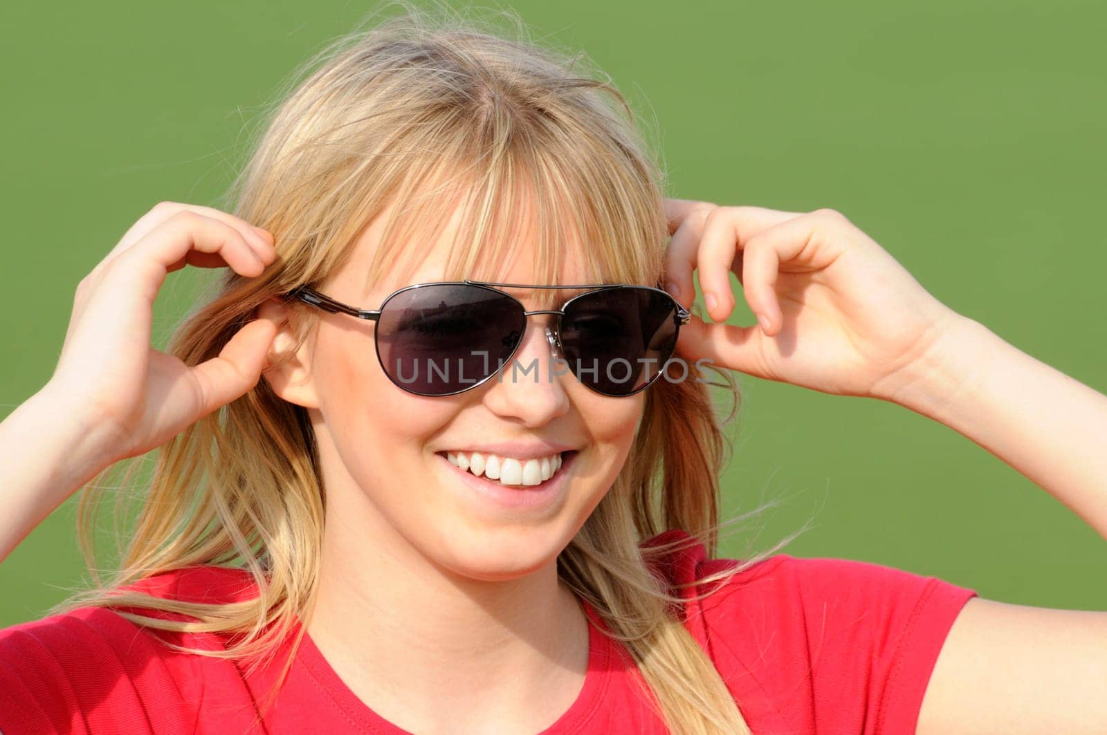 Laughing young woman in sunglasses