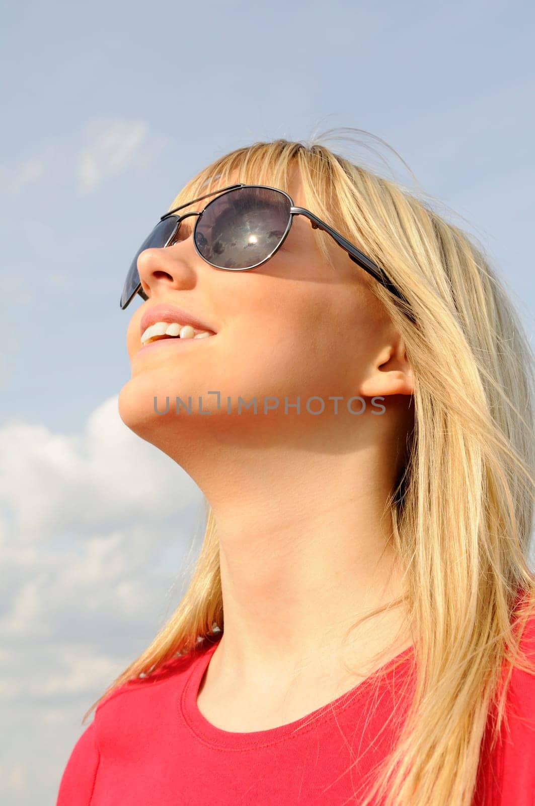 Laughing young woman in sunglasses